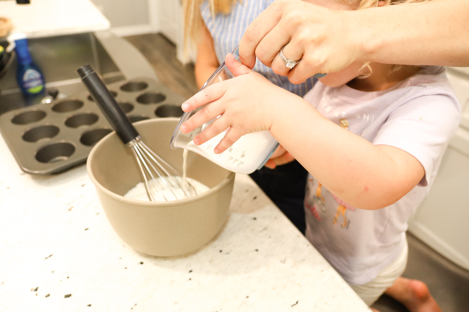 Mom pouring batter with child, healthy lifestyle